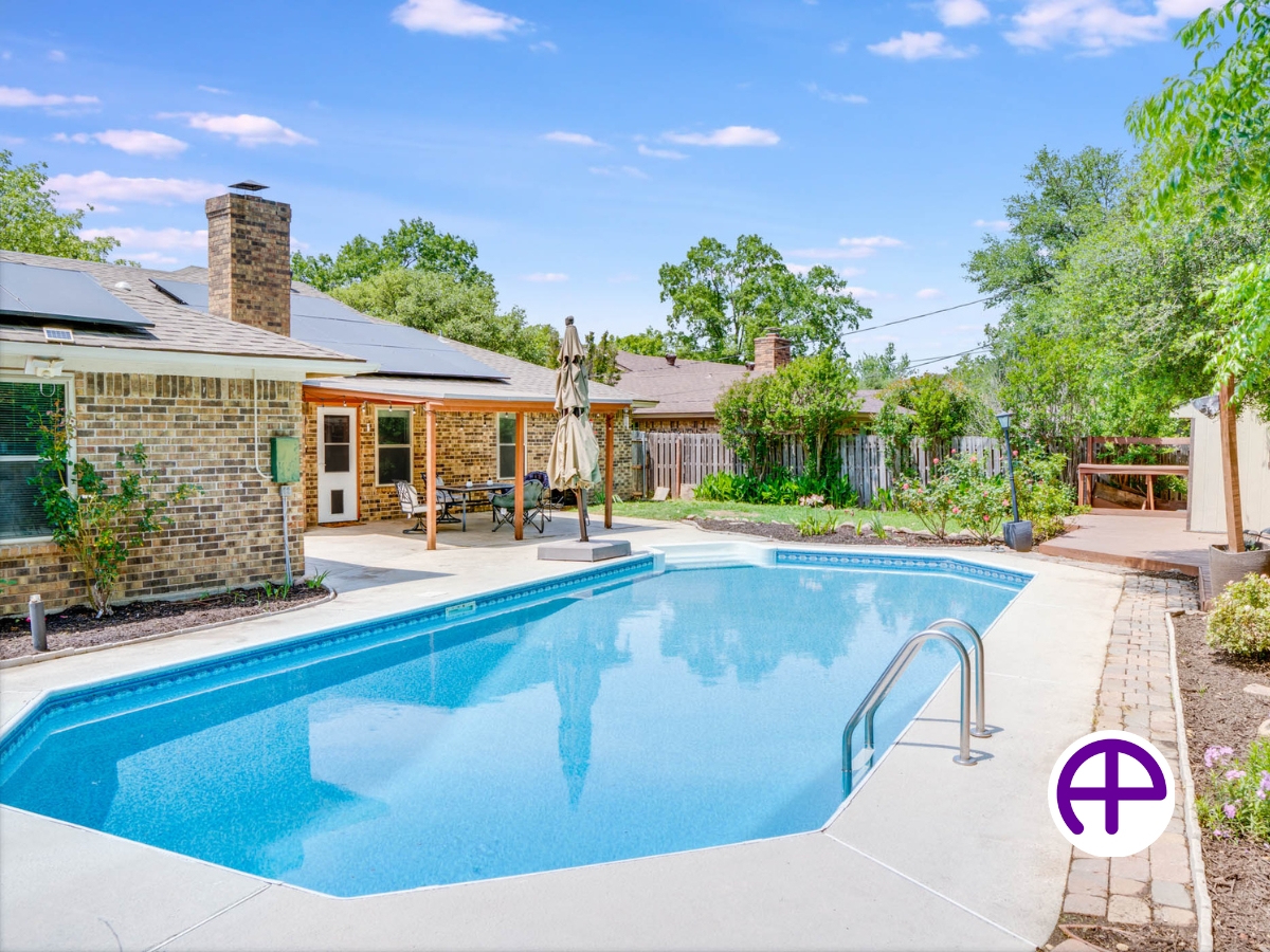 Exterior photo of single-story ranch-style home with a beautiful pool in the backyard enhanced by accuskyreplacements™ service
