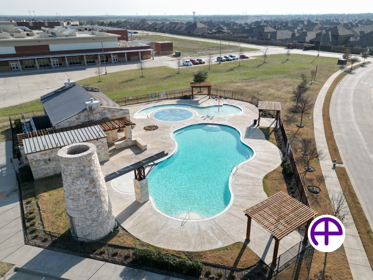 Community pool seen from the side with a mesmerizing aerial view