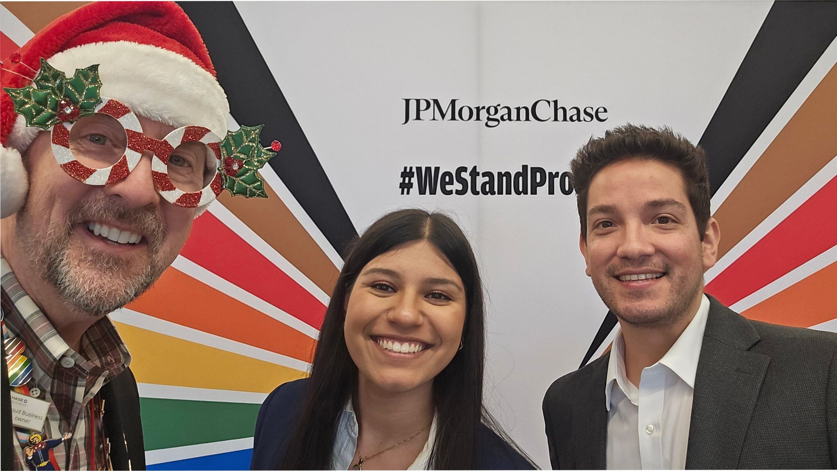 Rick a. Fogerty, amanda uribe, and roger belmontes in front of the jpmorgan chase #westandproud backdrop at the chase pride showcase in plano.