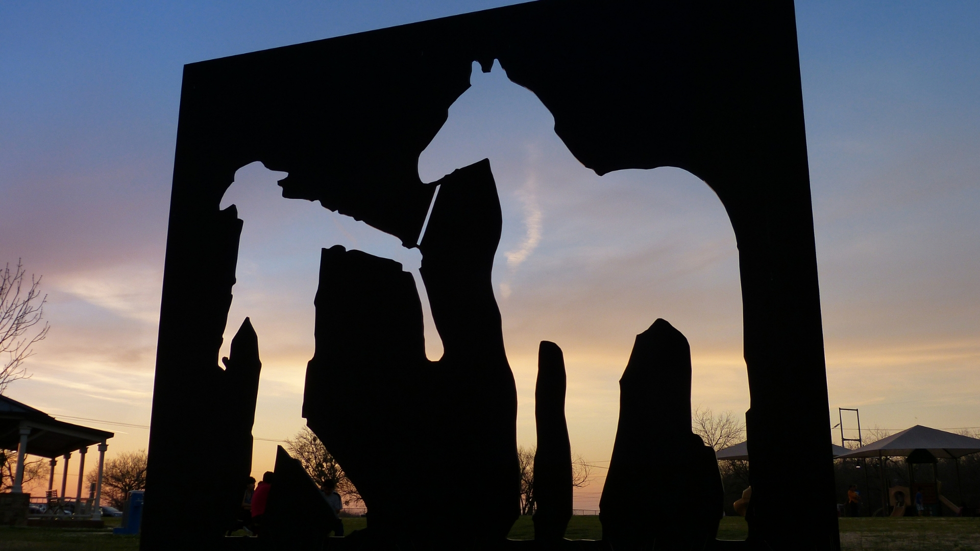 Award-winning sunset photo of a cowboy with his horse art installation at north lake ranch park in valley ranch, irving, texas, a prime location for accuphotography's acculocations services in the dfw metroplex.